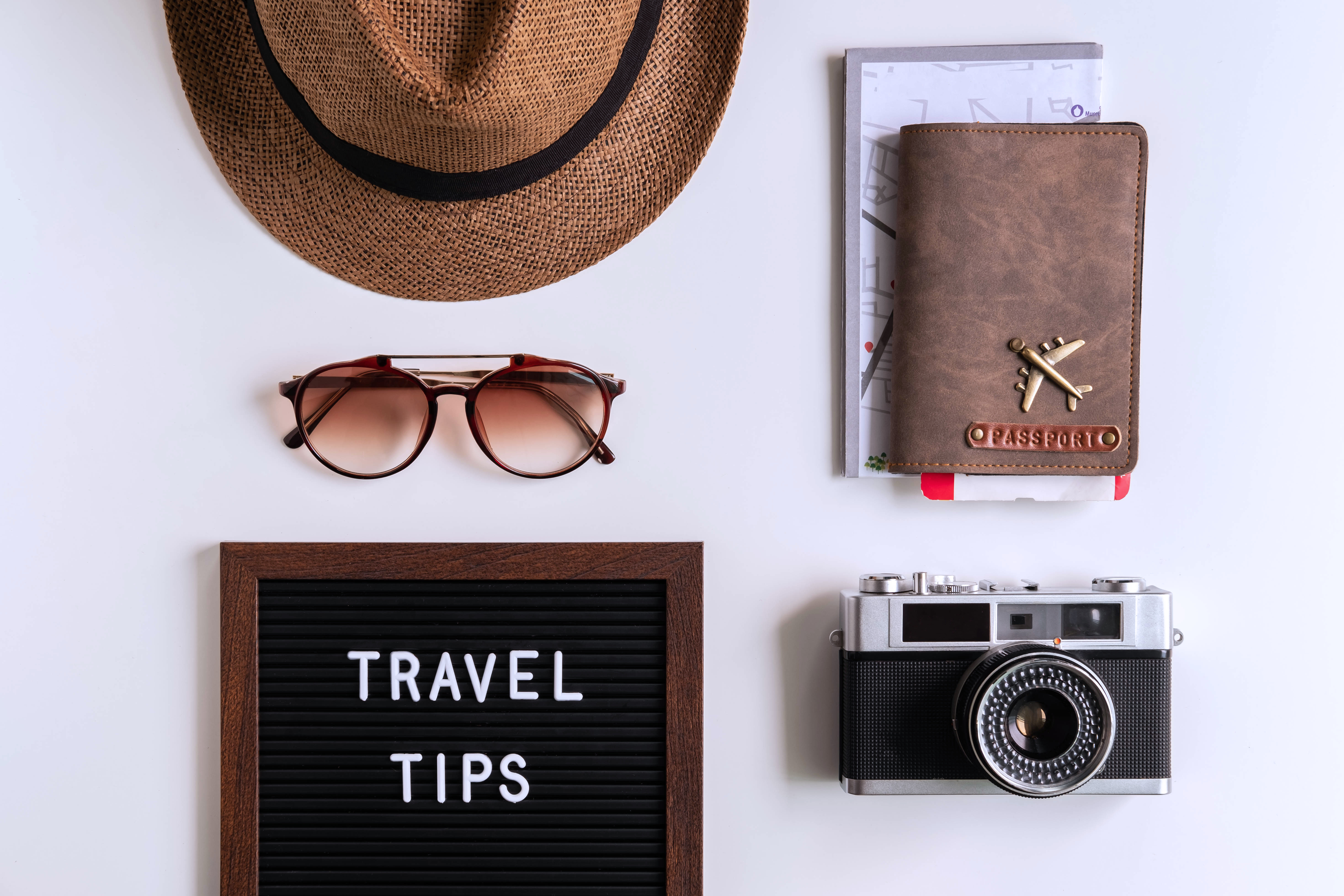 Retro camera with  toy plane, map and passport on white background, Travel tips concept deals on hotels