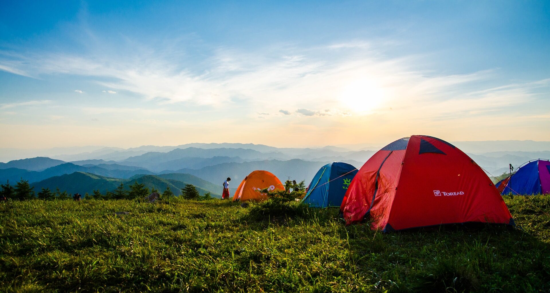 Pitched Dome Tents Overlooking Mountain Ranges