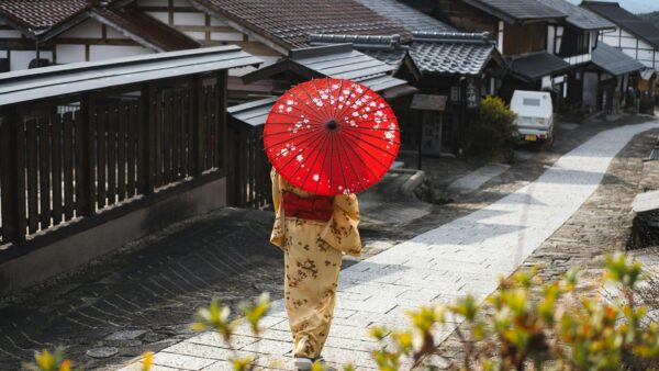 japan for first timers - geisha with a red umbrella
