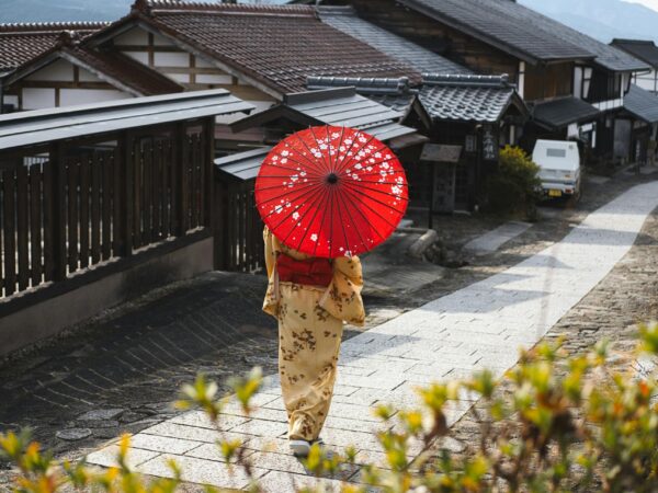 japan for first timers - geisha with a red umbrella